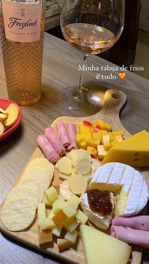 Cheese Crackers And Meats On A Wooden Platter Next To A Glass Of Wine