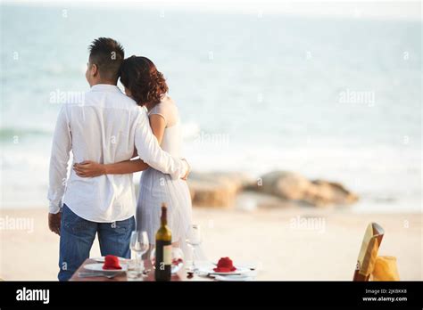 Young couple having romantic dinner on the beach Stock Photo - Alamy