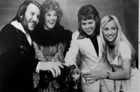 three women and one man are posing for the camera