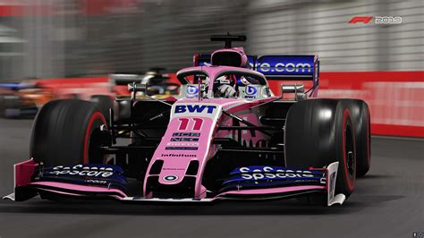 Download A Pink Racing Car Is Driving Down The Track | Wallpapers.com