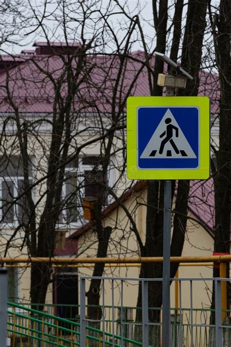 A Road Sign Indicating A Pedestrian Crossing Across The Road In The