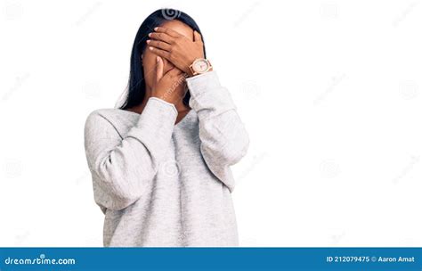 Hispanic Woman With Long Hair Wearing Casual Clothes Covering Eyes And