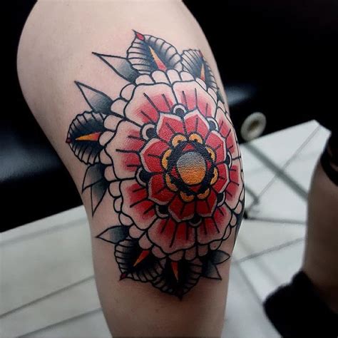 Traditional red mandala tattoo on the knee - Tattoogrid.net