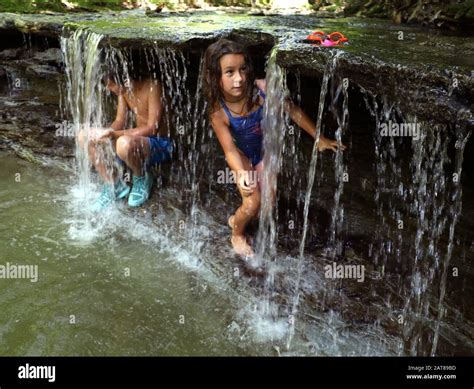 Family kids playing in creek waterfall Ohio USA Stock Photo - Alamy