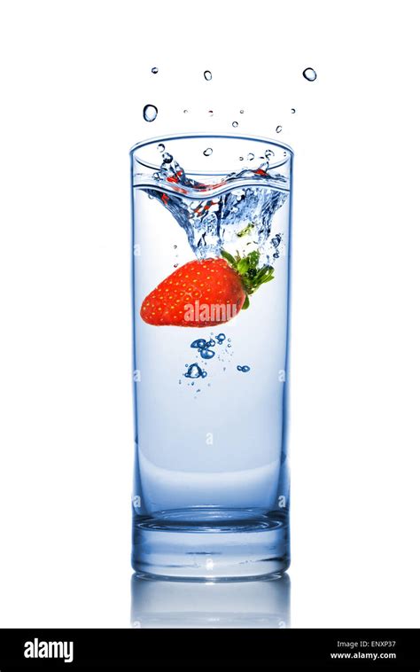 Strawberry Dropped Into Water Glass With Splash Isolated On White Stock