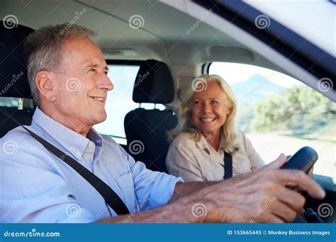 Senior White Man Driving Car His Wife Beside Him In The Front