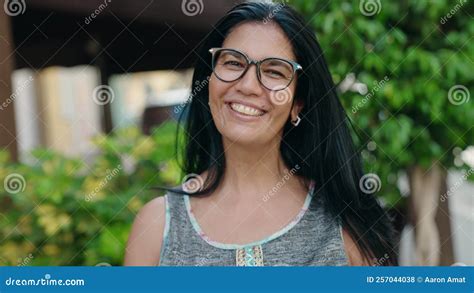 Middle Age Hispanic Woman Smiling Confident Wearing Glasses At Street