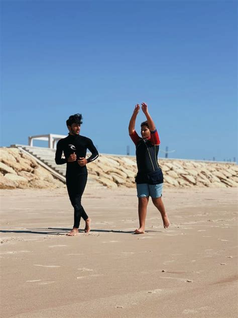 Man and a Woman Jogging on Beach Shore · Free Stock Photo