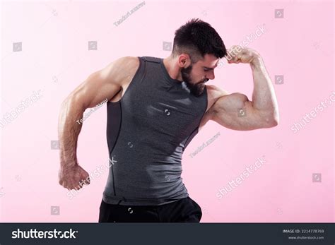 Strong Man Bodybuilder Flexing His Biceps Stock Photo 2214778769