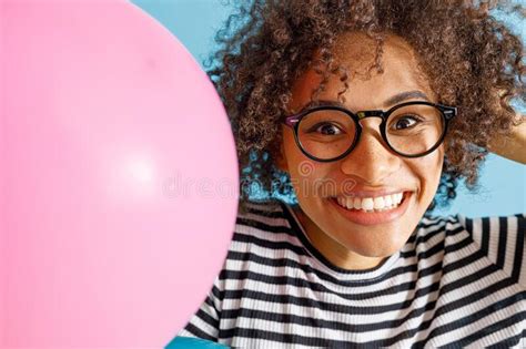 Cheerful Multiethnic Woman Holding Pink Party Balloon Stock Image