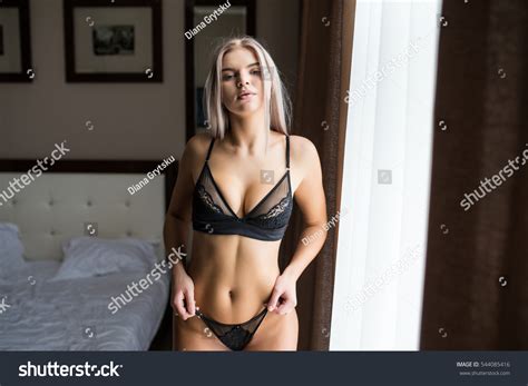 Foto Stok Sexy Blonde Girl Near Bed Edit Sekarang 544085416