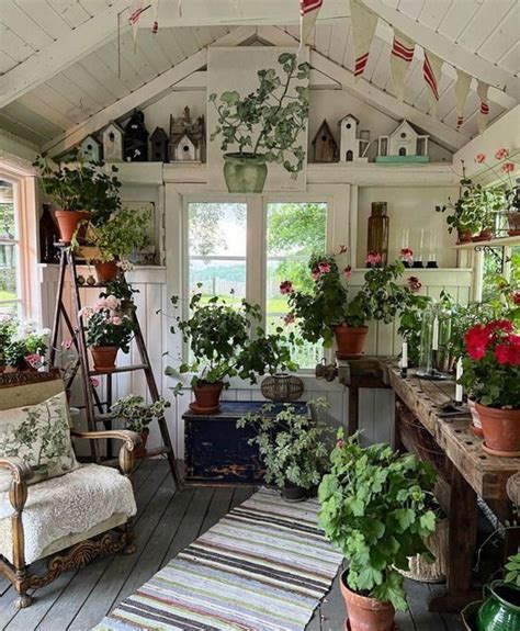 A Room Filled With Lots Of Potted Plants On Top Of Wooden Flooring Next