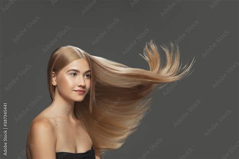 Shine Beautiful Model With Long Smooth Flying Blonde Hair On Dark