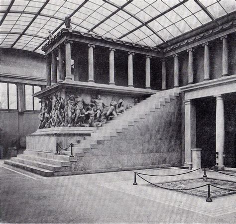 this is an old photo of the inside of a building with stairs and statues on it