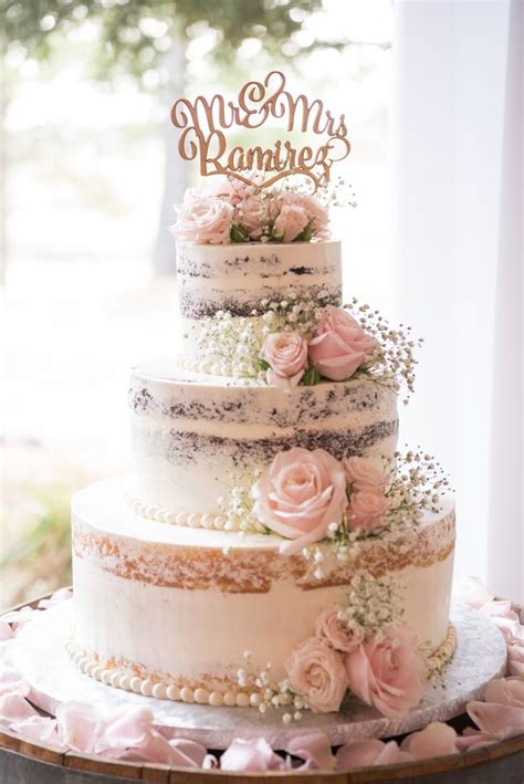 Naked Wedding Cake With Pink Flowers And Mr And Mrs Topper