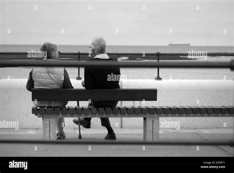 Vieux Couple Assis Sur La Plage Banque Dimages Noir Et Blanc Alamy