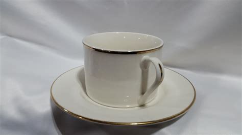 Gold rimmed coffee cup and saucer | Platinum Event Rentals