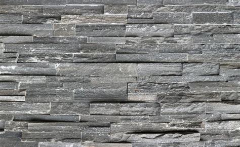 Stone Cladding Wall Made Of Striped Stacked Slabs Of Natural Dark Gray