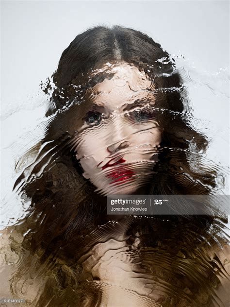 Stock Photo Distorted Image Of Female Shot Through Wet Glass