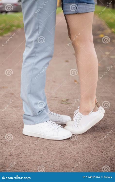 Close Up Of Small Girlfriend Standing Tiptoe To Kiss Lover Stock Image