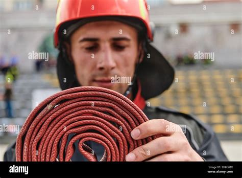 Professional Firefighter Cleaning Up Fire Hose After Extinguishing