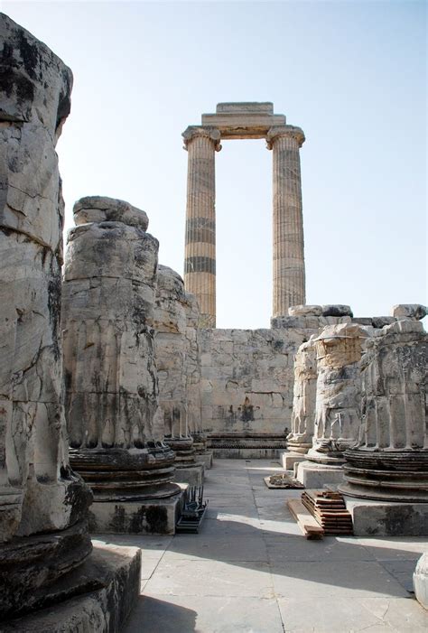 An Ancient Building With Columns In The Background