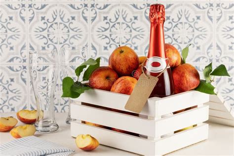 Bottle With Cider Glasses And Apples In A White Wooden Box Stock Image