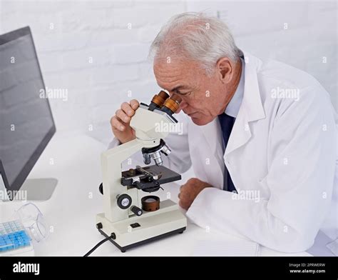 Science Is All About Observation A Mature Scientist Using A Microscope