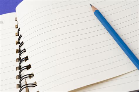 stock photo  pencil lying   blank notebook freeimageslive