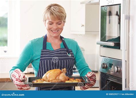 Woman In Kitchen Holding Tray With Roast Chicken Stock Image Image Of