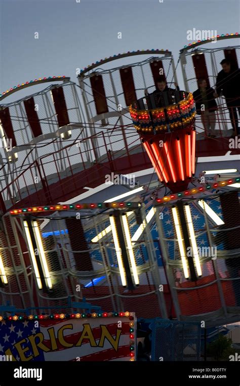 Spinning Round-Up Amusement Ride at Night Stock Photo - Alamy