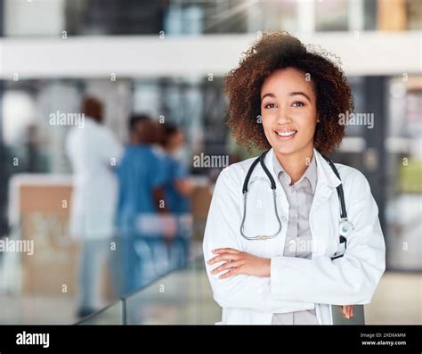 Medical, portrait and woman with arms crossed in hospital with smile ...