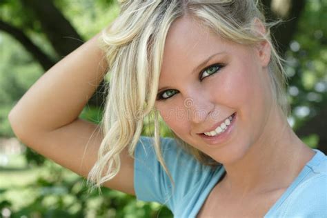 Portrait Of A Young Beautiful Blonde Model Posing With A Flower Stock