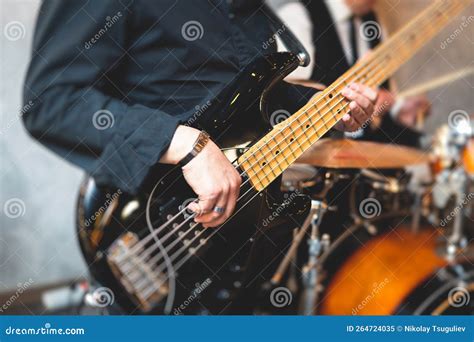 Concert View Of A Musician Electric Bass Guitar Player With During