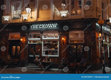 People Sitting At The Outdoor Tables Of The Crown Pub On Seven Dials In