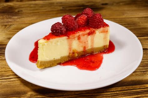 Premium Photo Piece Of Tasty New York Cheesecake With Raspberries And