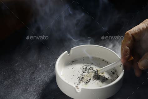 Hand Putting The Cigarette On An Ashtray Stock Photo By Amenic