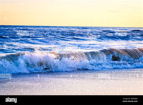 Amazing beach sunset with incredible sparkling waves. Sunset and sea ...