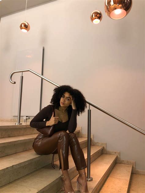 A Woman Is Sitting On The Stairs With Her Legs Crossed