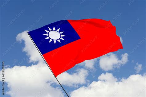 Taiwan flag isolated on the blue sky background. close up waving flag of Taiwan. flag symbols of ...