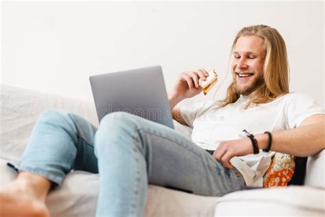 Bearded Blonde Man Eating Sandwich While Working With Laptop Stock Image Image Of Blonde