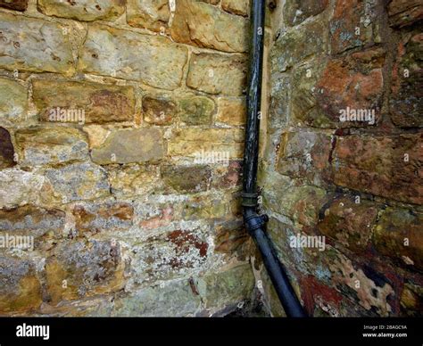 Metal Rainwater Downpipes Against Stone Wall Abstract Stock Photo Alamy