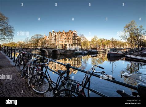 The Netherlands Amsterdam Canal Houses And Houseboats In Canal Called