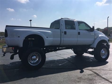 A White Pickup Truck Parked In A Parking Lot