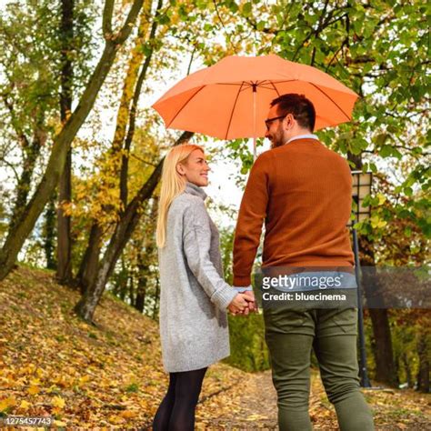 Man Holding Umbrella Over Woman Photos And Premium High Res Pictures