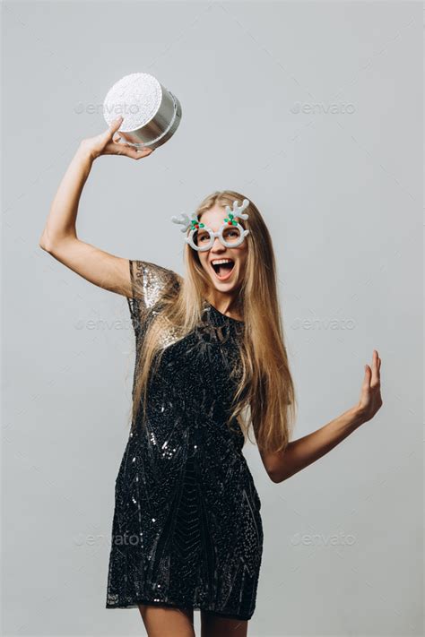 Merry Christmas A Happy Blonde Woman In A Festive Dress Holding Christmas Presents Stock Photo