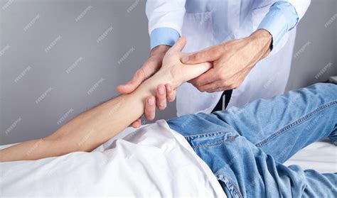 Premium Photo Caucasian Doctor Massaging Patient Hand