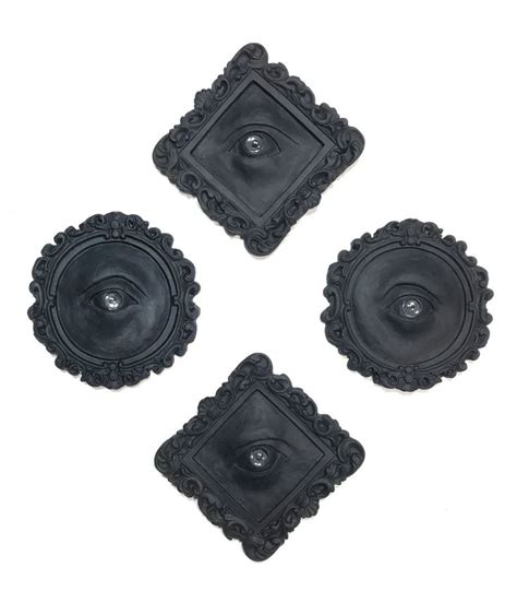 Four Black Ceramic Coasters With An Eye In The Center