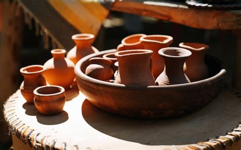 Premium Photo | Simple homemade clay crafts jugs and cups outdoors on a sunny day closeup ...