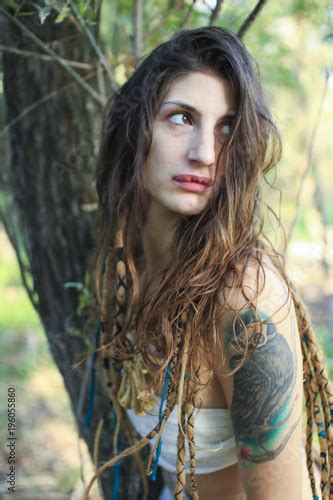 Beautiful Pagan Woman Looking Behind Her Back In The Forest Stock